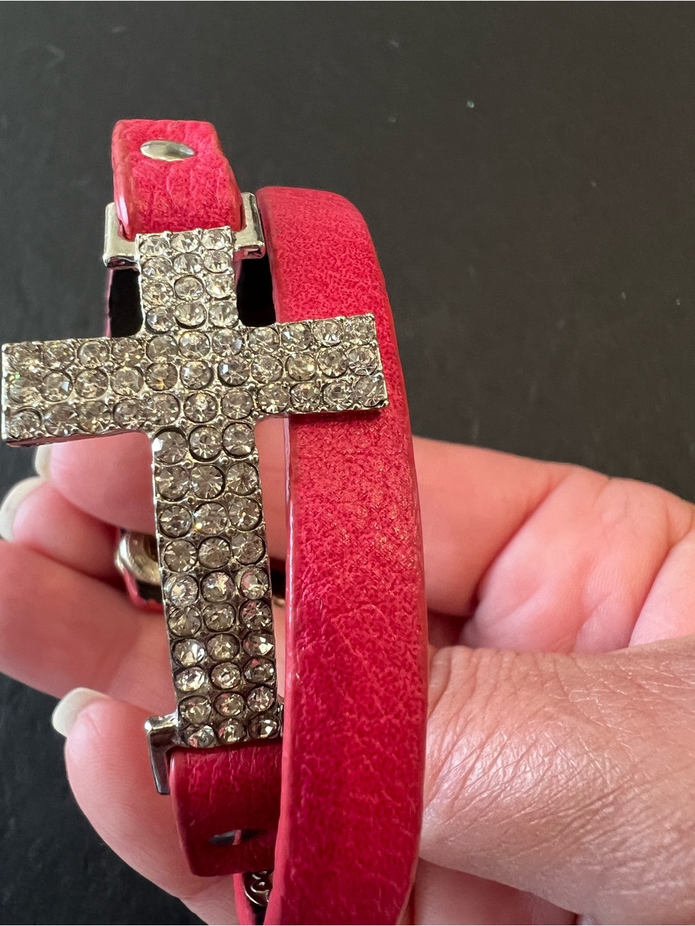Red/Pinkish Faux Leather Wrap Bracelet Featuring A Rhinestone Embellished Cross